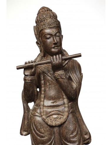 Statue of Krishna playing the...